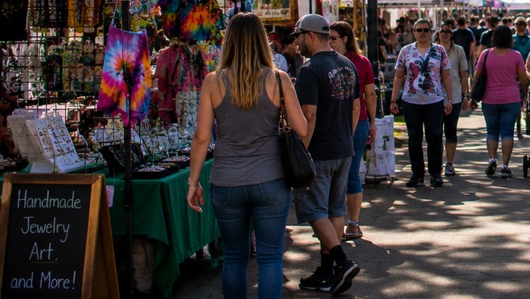 People browsing market booths